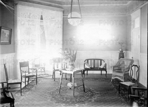 Unknown interior of Victorian family home with fine furniture, brass bed, c1900s.. Creator: Robert Augustus Henry L'Estrange.