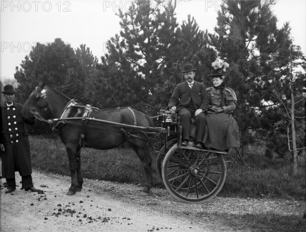 Unknown people in horse drawn cart and coachman; possibly Chester, England (Bache Hall), 1895. Creator: Robert Augustus Henry L'Estrange.