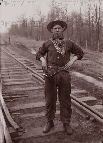 Untitled (man with pistol on railroad tracks, neg. #14), between 1910 and 1935, printed c1975. Creator: Wendell Hotter.