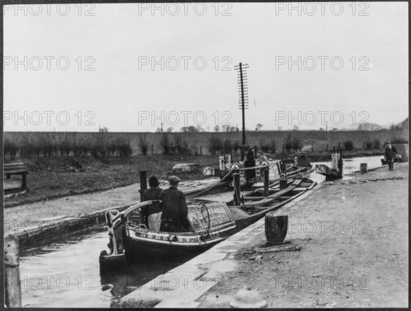 Two canal barges passing through a lock on the Grand Union Canal near Marsworth, Bucks, 1920-50.  Creator: George R Long.