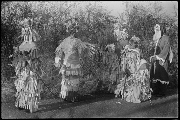 A group of people in costume performing in a Mummers' play, Andover, Test Valley, Hampshire, 1948. Creator: George R Long.