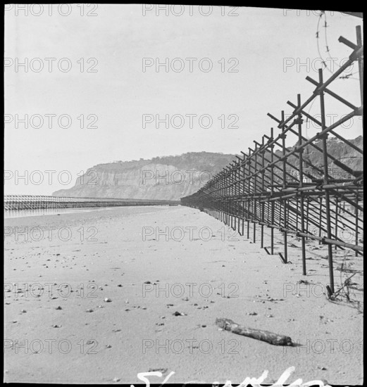 View looking south along the beach at Shanklin, showing Admiralty scaffolding, Isle Of Wight, 1945. Creator: George R Long.