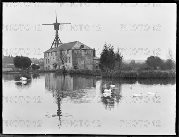West Ashling Mill from north-west across the mill pond, Mill Road, Funtington, West Sussex, 1920-50. Creator: George R Long.