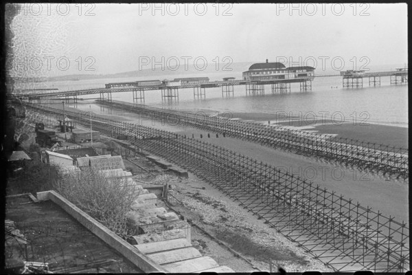Looking north-east over the beach at Shanklin, showing Admiralty scaffolding, Isle Of Wight, 1945. Creator: George R Long.