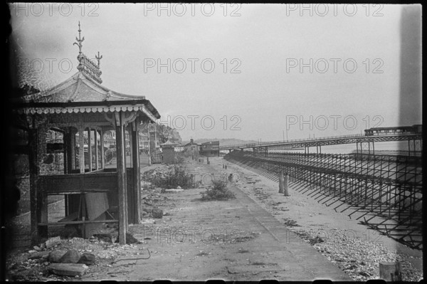 View along the Esplanade from beside a shelter, showing Admiralty scaffolding, Shanklin, IoW, 1945. Creator: George R Long.