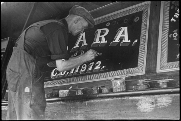 Barge painter Frank Jones, of 3 Edward Street, at work, Leighton Buzzard, Bedfordshire, 1910-60. Creator: George R Long.