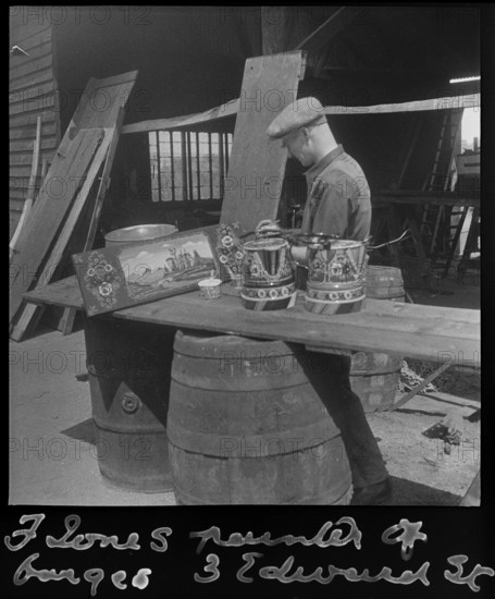 Barge painter Frank Jones, of 3 Edward Street, at work, Leighton Buzzard, Bedfordshire, 1910-60. Creator: George R Long.