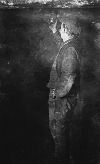 Coal Mining, Fireman searching for Gas postcard, c1900s. Creator: Unknown.