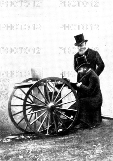 The Prince of Wales firing a Maxim Gun: Mr. Maxim standing by, 1898. Creator: Russell & Sons.