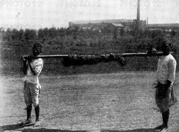 Scenes in Plague-Stricken Bombay: removing body of a...child to the...burning-ground, 1898. Creator: Gysi.