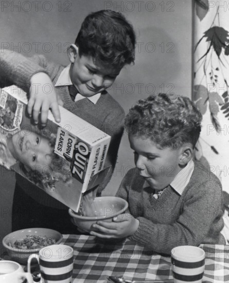 Two boys having a bowl of Quiz Corn Flakes, c1955.  Creator: Arthur Charles Kirby Ware.