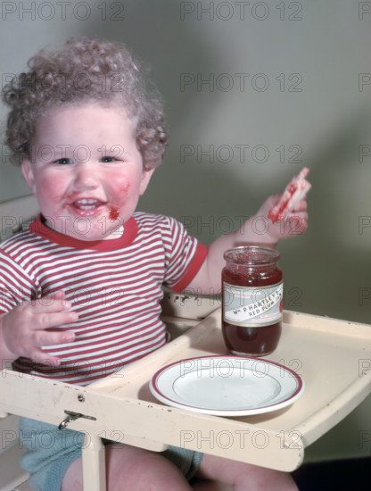 Young child eating P Hartley's Red Plum Jam and bread, c1955.  Creator: Arthur Charles Kirby Ware.