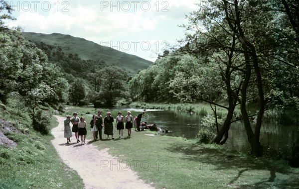 People walking alongside a river in Dovedale, Derbyshire, c1955-1965. Creator: Arthur Charles Kirby Ware.