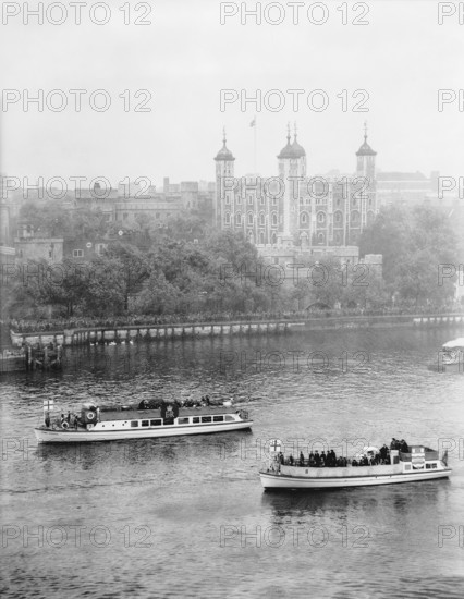 Boats passing along the Thames in front of the Tower of London, c1955. Creator: Arthur Charles Kirby Ware.