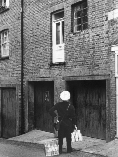 Confused milkman confronted with a doorstep on the first floor, c1955. Creator: Arthur Charles Kirby Ware.