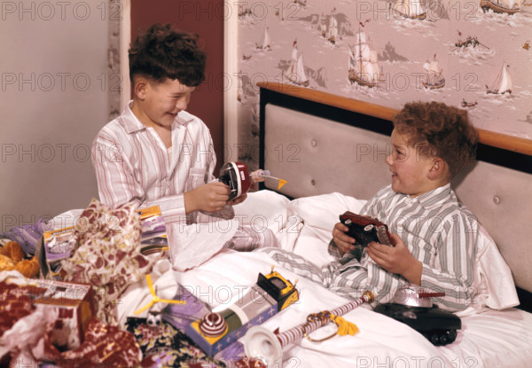 Two boys opening presents at Christmas, c1955-1965. Creator: Arthur Charles Kirby Ware.