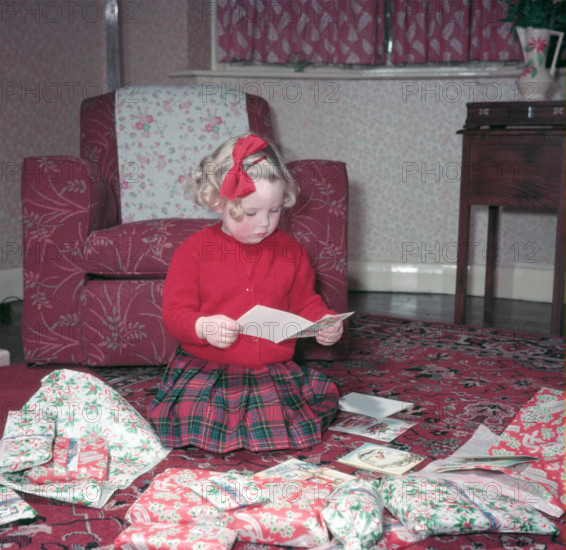 Girl opening her Christmas cards and presents, c1955.  Creator: Arthur Charles Kirby Ware.