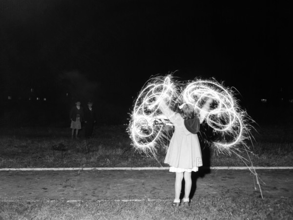 Children with fireworks, c1955. Creator: Arthur Charles Kirby Ware.