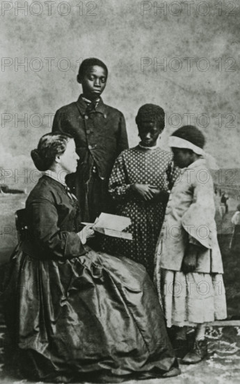 Portrait of teacher Laura M. Towne, a founder of the Penn School, with students..., February 1866. Creator: Unknown.