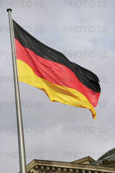 German flag next to the Reichstag building, Berlin, Germany, 2025.  Creator: LTL.