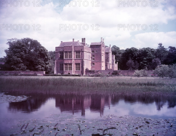 Broughton Castle and moat, Oxfordshire, c1955. [gateway, church] Creator: Arthur Charles Kirby Ware.