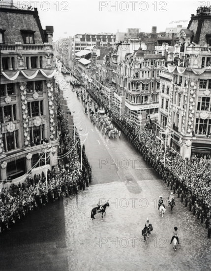 Crowds watching the coronation procession of Queen Elizabeth II, Oxford Circus, London, 2 June 1953. Creator: Arthur Charles Kirby Ware.