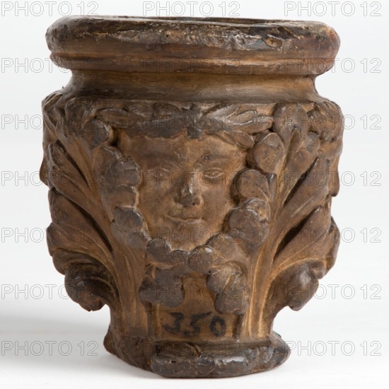 Cast of a medieval capital with leaf foliage and faces, possibly representing the Green Man, c1870. Creator: Unknown.
