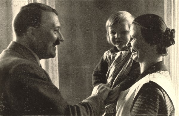 Hitler, on holiday in Obersalzberg, greeting a mother and her child