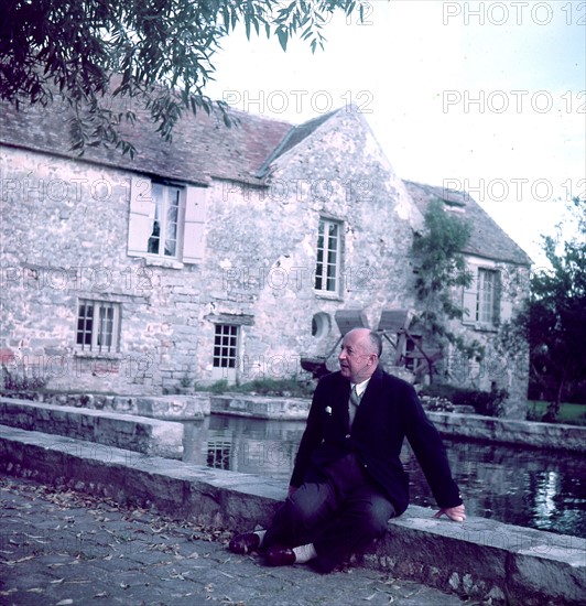 Christian Dior in front of his house in Milly-la-Forêt