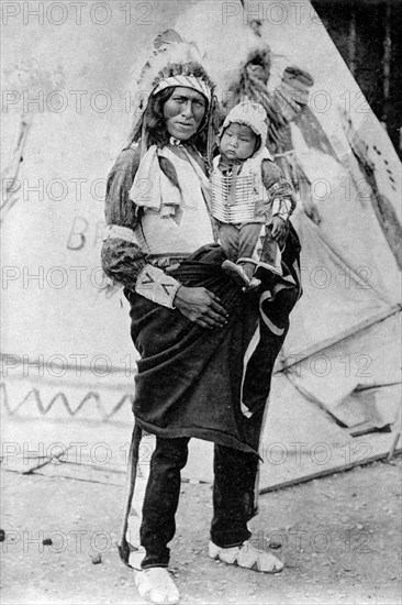 Tron Bull and son, Sioux Indians, at the Red Indian village in the Zoological Garden of Paris.