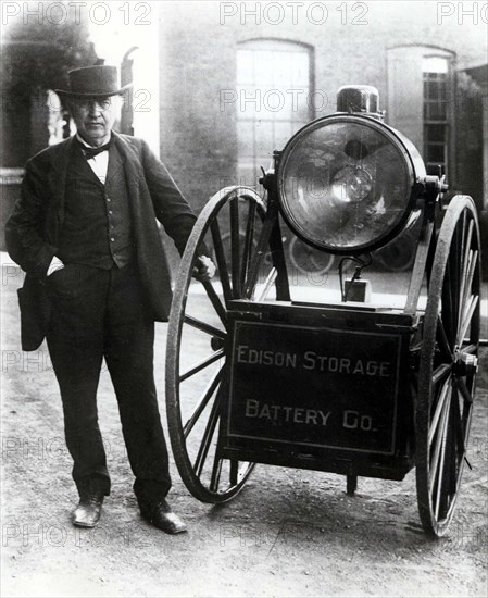 Edison standing by his new accumulators for projectors (1917)