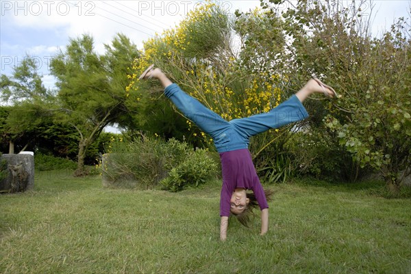 Girl making sport in a garden