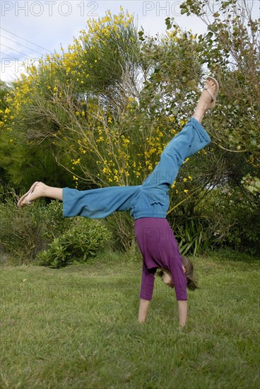 Girl making sport in a garden