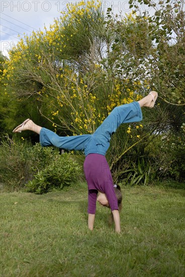 Girl making sport in a garden