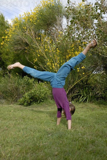 Girl making sport in a garden