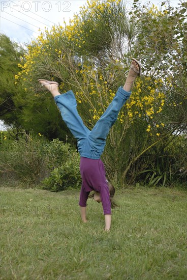 Girl making sport in a garden