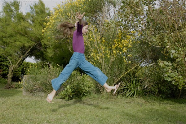 Girl making sport in a garden