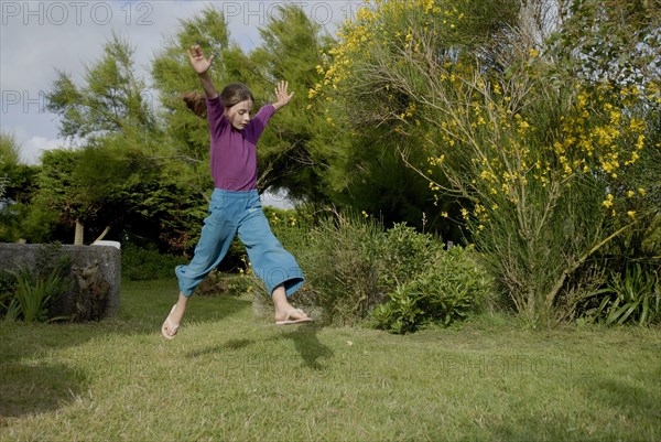 Girl making sport in a garden