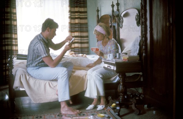 Johnny Hallyday and Sylvie Vartan in a hotel room during a tour