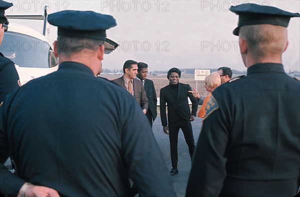 James Brown standing by his private airplane at the Long Island airport.