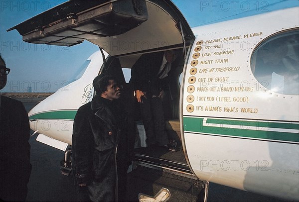 James Brown standing by his private airplane at the Long Island airport.