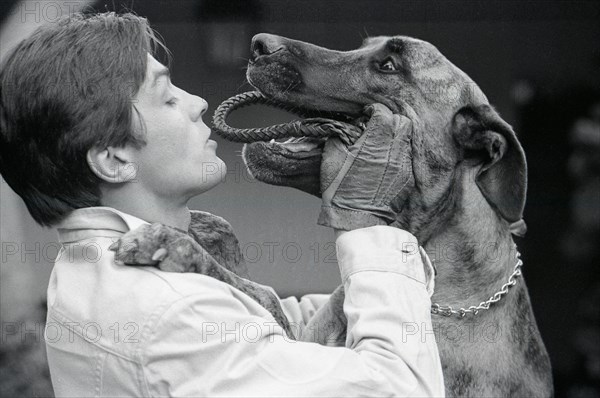 Alain Delon playing with his dog