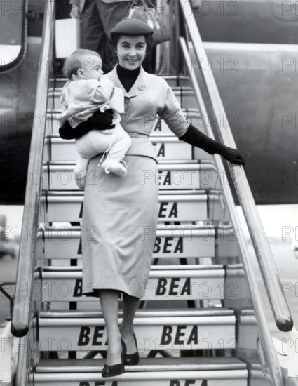 Elizabeth TAYLOR gets off the plane with her son