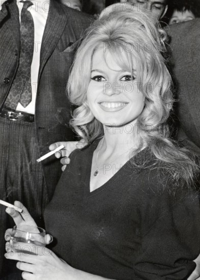 Brigitte BARDOT, portrait with cigarette and drinking glass