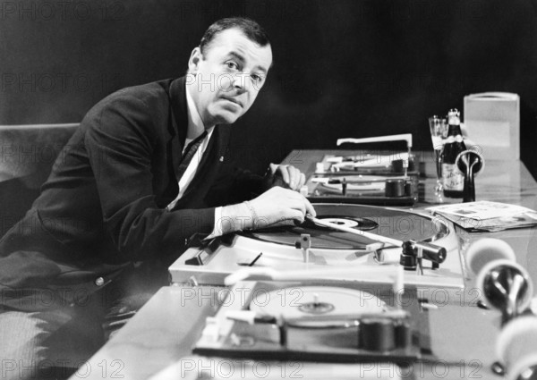 Chris HOWLAND in front of record players, undated