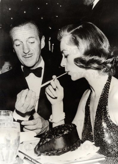 David NIVEN and Lauren BACALL at a party