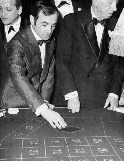 Charles AZNAVOUR at 'Maxim's' playing roulette, Paris circa 1960s