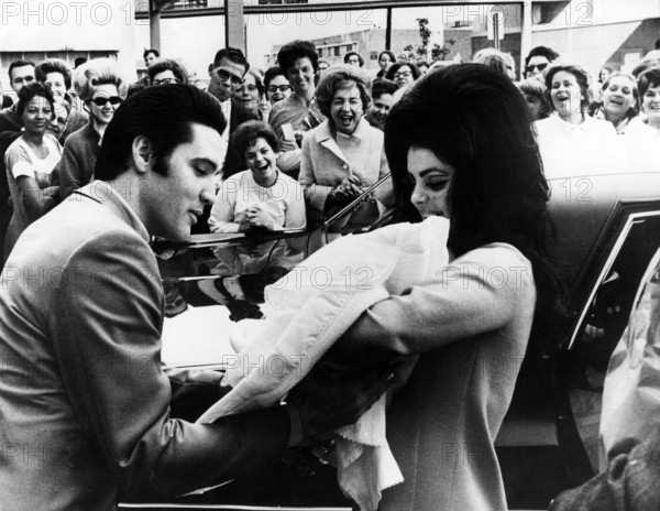 Elvis PRESLEY with his wife and daughter leaving the Baptist Hospital, 1968