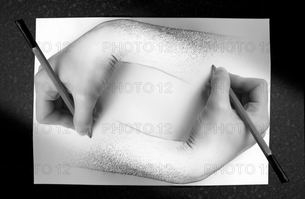 A recreation of MC Eschers famous graphic art photograph 'Drawing Hands' originally created in 1948.