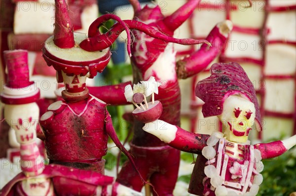 Two holidays combine: radishes are carved into figures celebrating Dia de los Muertos for a tableau at Oaxaca's Noche de Rabanos